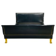 a black leather bed with gold trimmings