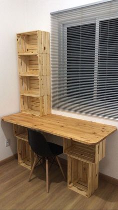 a wooden desk sitting next to a window