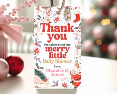 a christmas gift bag with the words thank you for celebrating our merry little baby shower