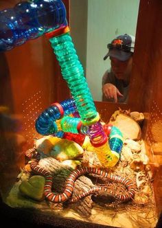 a man is looking at an assortment of glass objects