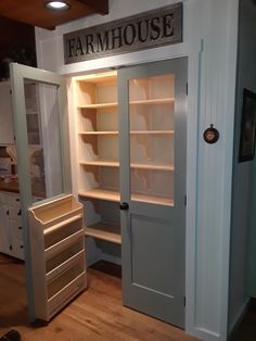 an empty pantry with two open doors and shelves