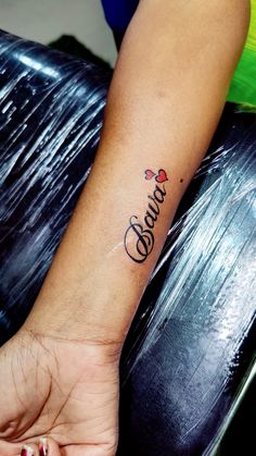 a woman's arm with a tattoo that reads, love and hearts on it