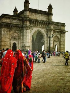 some people are standing in front of an old building