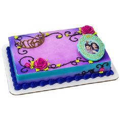 a birthday cake with an image of two people on it, and flowers around the edges