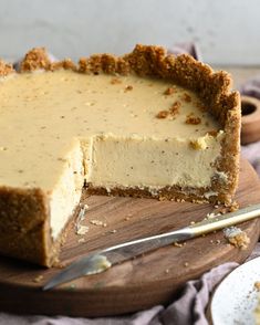 a piece of cheesecake on a wooden cutting board