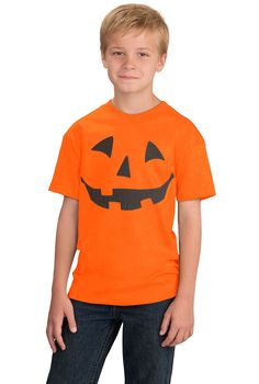 a young boy wearing an orange shirt with a jack - o'- lantern face on it