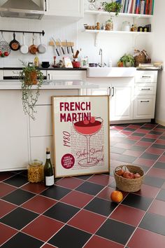 a kitchen with black and red tiles on the floor