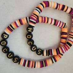 three necklaces with words written on them sitting next to each other in front of a white background