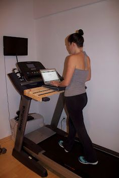 a woman on a treadmill using a laptop computer to track her progress in the gym