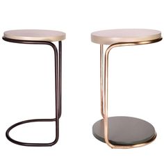 two side tables with metal bases and one has a circular base on the top, while the other is round