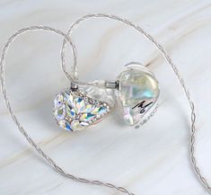 a white necklace with a heart shaped pendant