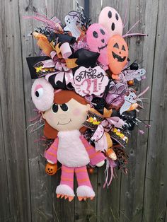 a wreath made to look like a girl with lots of halloween decorations