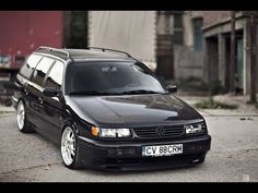 a black car parked in front of a building