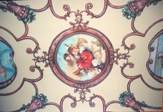 the ceiling is decorated with an artistic painting