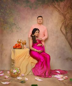 a man standing next to a woman in a pink dress