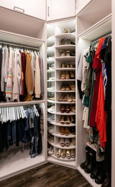 an organized closet with shoes, scarves and sweaters hanging on the shelves next to each other