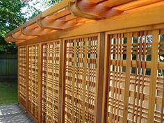 a wooden fence with lattice design on it