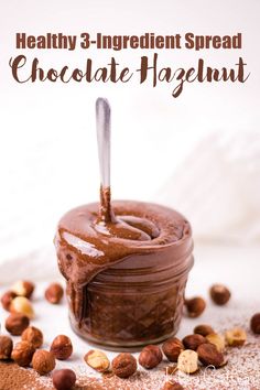 chocolate spread in a jar with nuts scattered around it and the words healthy 3 ingredient spread chocolate hazel hazelnut