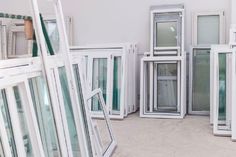 a room filled with lots of different types of window panes on the floor and walls