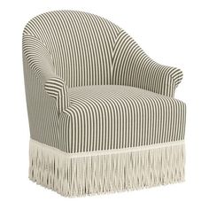 an upholstered chair with fringe trimmings on the legs and back, in black and white striped fabric