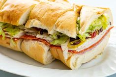 a cut in half sandwich sitting on top of a white plate