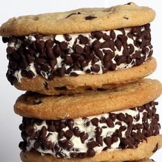 three cookies stacked on top of each other covered in chocolate chips and white frosting