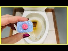 a person holding a soap bar in front of a toilet