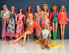 a group of barbie dolls standing next to each other