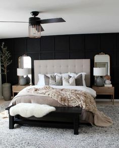 a bedroom with black walls, white carpet and a large bed in the middle of it