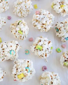 white chocolate popcorn balls with sprinkles and m & m candies on top