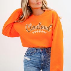 The Cleveland Football Sweatshirt for women is perfect GameDay apparel, offering a stylish way to show team spirit. This sweatshirt makes a great gift for a sport fan and is an ideal outfit idea for tailgate accessories for any girl. ✨ DETAILS ✨ ☆ Gildan 18000 unisex sweatshirt ☆ 50% Cotton (100% ethically grown in the US); 50% polyester ☆ Without side seams: Knit in one piece using tubular knit ☆ Ribbed knit collar with seam: Tightly elastic and retains shape effectively ✨ CARE INSTRUCTOINS ✨ ☆ Machine wash: cold (max 30oC or 90oF) ☆ Use non-chlorine bleach as needed ☆ Tumble dry on low heat ☆ Do not iron ☆ Do not dry clean  ✨ YOU MIGHT ALSO LIKE ✨ 📌 https://www.etsy.com/listing/1636664031/cleveland-football-sweatshirt-gift-for 📌 https://www.etsy.com/listing/1653514695/custom-team-footb Varsity Tops For Fall Sports Events, Team-colored Tops For Sports Events In Fall, Fall Varsity Style Tops For Sports Events, Varsity Tops For Sports Events In Fall, Varsity Style Tops For Fall Sports Events, Fall Sports Team Logo Tops, Fall Sports Event Tops With Team Logo, Team-colored Fall Sports Sweatshirt, Team-colored Sweatshirt For Sports In Fall