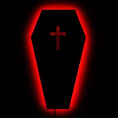 a lighted casket with a cross on the front and side in red light, against a black background