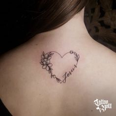 a woman's back neck with a heart and flowers tattoo on her left side