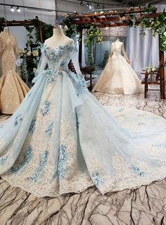 If you are looking for a perfect and long lace for your marriage, this mind-blowing ball gown with a scoop neckline is perfect for you. Some well-fitted hand made flowers are added across the neckline along with the long Sleeve that is also added to it. The back of the gown is also well decorated with a premium lace-up back style and a small opening that is also added to bring out the beauty of the gown. The skirt of the gown has a design that is spread across part of it. It has some flapping de Ball Gowns Fantasy, Blue Ball Gown, Women Robe, Blue Ball Gowns, 파티 드레스, Blue Ball, Princess Ball Gowns, Backless Wedding, Wedding Dresses Beaded