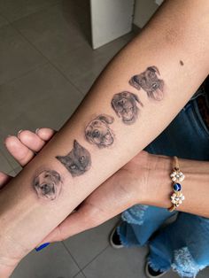 a woman's arm with dogs on it and the word love written in cursive writing