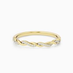 a yellow gold ring with white diamonds on the sides and a twisted design in the middle