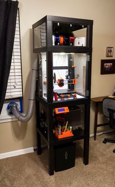 a room with a desk and shelves filled with assorted items, including legos