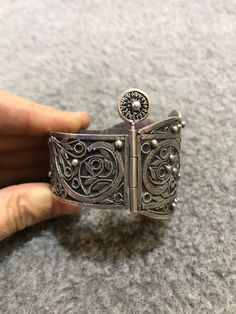 A beautiful antique Algerian silver bracelet with Morocco silver marks, silver filigree, with a sliding pin closure. Handmade from 80 percent silver. The filigree is in good condition and the bracelet functions as it should. It is in general in good vintage condition. Width of large side : 5cm Width of small side : 2,8 cm Inner diameter : 5,9cm Weight : 67,9g Traditional Adjustable Filigree Bracelets, Adjustable Traditional Filigree Bracelets, Bohemian Filigree Cuff Bracelet, Antique Silver Bracelet With Intricate Design, Ornate Ceremonial Bracelet With Intricate Design, Bohemian Antique Silver Bracelet With Intricate Design, Ornate Handmade Antique Silver Bracelet, Traditional Filigree Cuff Bracelet Bangle, Traditional Filigree Cuff Bangle Bracelet