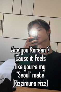 a man taking a selfie in front of a mirror with the caption are you korean? cause it feels like you're my seoul mate