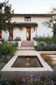 an outdoor fountain in front of a house