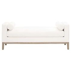 a white couch sitting on top of a wooden frame