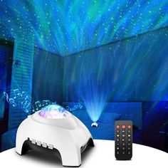 a remote control sitting on top of a table in front of a projection screen with stars