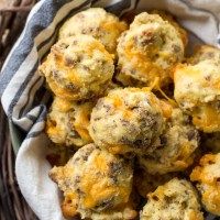 a basket filled with cheesy meatballs on top of a cloth covered table