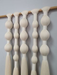 a group of white wooden beads hanging on a wall