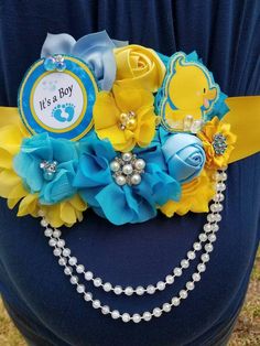 a blue and yellow baby shower bouquet with pearls