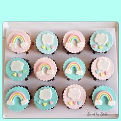 cupcakes decorated with pastel blue icing and rainbow designs