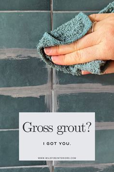 a hand holding a micro towel over a tile wall with the words gross grout? i got you