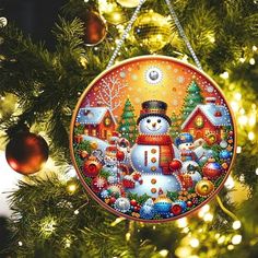 a snowman ornament hanging from a christmas tree