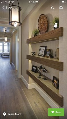 an image of a hallway with shelves and pictures on the wall above it, along with other items