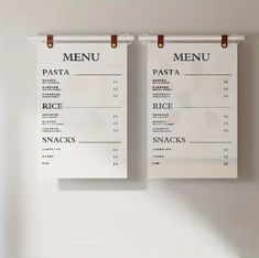 two menus hanging on the wall next to each other